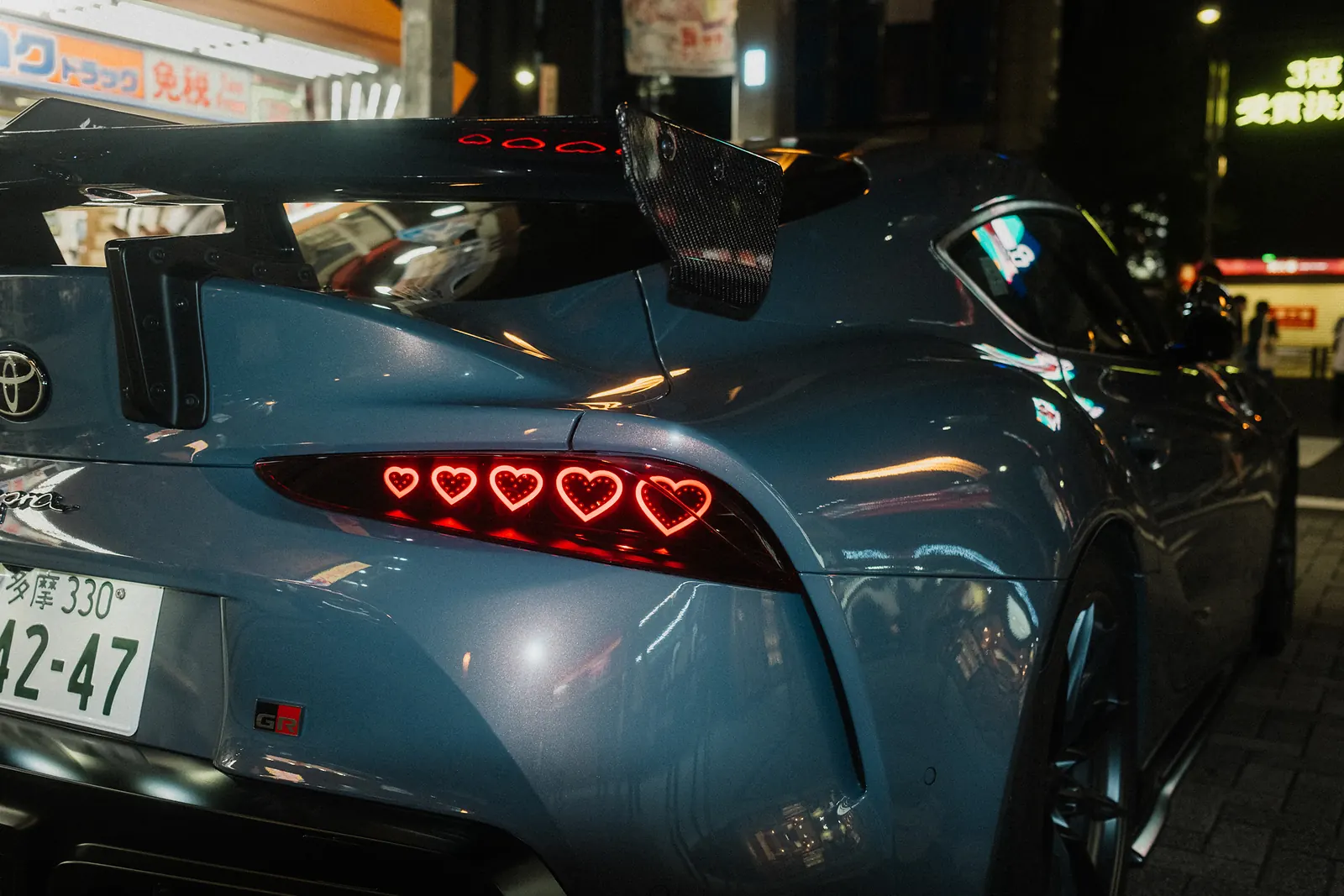Heart-shaped custom taillights on a blue Toyota GR Supra.